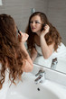 dressed in towel gorgeous woman makeup at modern bathroom