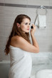 dressed in towel gorgeous woman makeup at modern bathroom