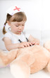 little girl doctor with teddy bear