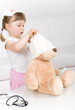 little girl doctor with teddy bear