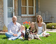 Photo: Family Sitting in Front of Their Home Family Sitting in Front of Their Home