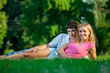 Couple resting on the grass in the park