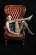 Beautiful model, photographed sitting on a big Chair