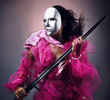Woman warrior in a silver mask with a sword in hands.