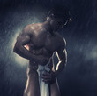 Young handsome athlete standing in the rain Young handsome athlete standing in the rain