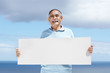 Smiling senior man holding a blank billboard