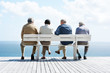 Photo: Group of old male friends sitting together on bench Group of old male friends sitting together on bench