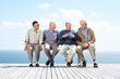 Discussion - Group of mature male friends sitting together on be