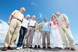 Group of mature friends standing on wooden plank