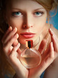 girl with a bottle of perfume in her hands