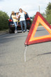 Photo: Family Broken Down On Country Road With Hazard Warning Sign Family Broken Down On Country Road With Hazard Warning Sign