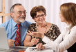 Senior couple meeting with agent or advisor Senior couple meeting with agent or advisor