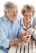 Happy old couple using a mobile phone