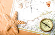 old map and compass on sand background old map and compass on sand background