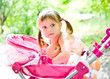 little girl with doll and carriage