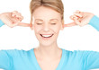 smiling woman with hands over ears