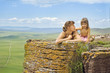 A woman with a child on a rock