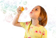 Little girl blows soap bubble