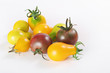 assorted baby heirloom tomatoes on white
