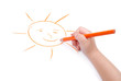 Childrens hand with pencil draws the sun