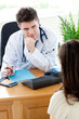 Assured male doctor talking with a patient during
