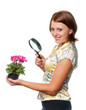 Smiling girl considers cyclamens through a magnifier Smiling girl considers cyclamens through a magnifier