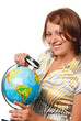 Smiling girl examines the globe through a magnifier Smiling girl examines the globe through a magnifier