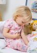 little girl in bed witch stomackache