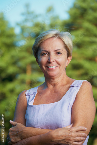Photo: Cheerful mature woman looking at camera Cheerful mature woman looking at camera