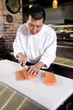 Photo: Japanese chef slicing raw fish for sushi Japanese chef slicing raw fish for sushi