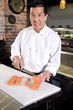 Photo: Japanese chef slicing raw fish for sushi Japanese chef slicing raw fish for sushi