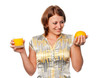Girl chooses between orange and orange juice Girl chooses between orange and orange juice