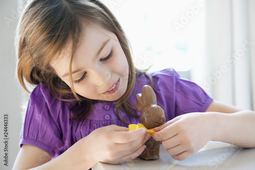 Photo: close-up of a girl playing with an easter bunny close-up of a girl playing with an easter bunny