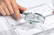 woman’s hand holding a magnifying glass woman’s hand holding a magnifying glass