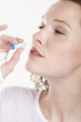 close-up of a woman taking homeopathic medicine