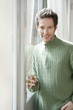 portrait of a man holding the handle of a door