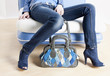 detail of woman wearing blue shoes and with handbag