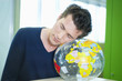 businessman napping on a globe in an office