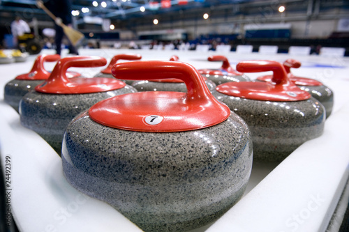 Photo: Group of curling rocks on ice Group of curling rocks on ice