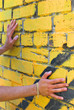 Man's hands touch the wall
