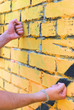 Mans fists touch the wall