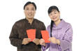 Couple wearing  traditional dress holding a red packet