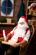 Photo: Santa Claus in Workshop With List Santa Claus in Workshop With List