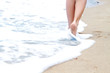 Closeup of a woman's legs walking on a beach Closeup of a woman's legs walking on a beach