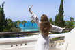 Young girl stretching on the hotel balcony
