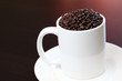 Coffee mug filled with fresh coffee beans Coffee mug filled with fresh coffee beans