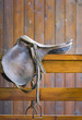 saddle on a wooden railing saddle on a wooden railing