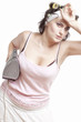 Photo: Housewife tired from ironing with curlers in her hair Housewife tired from ironing with curlers in her hair