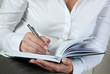 businesswoman writing on a notepad