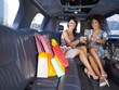 women drinking wine in limousine